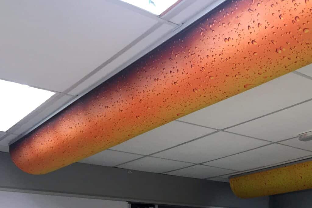 A Prihoda fabric duct with an orange printed design
