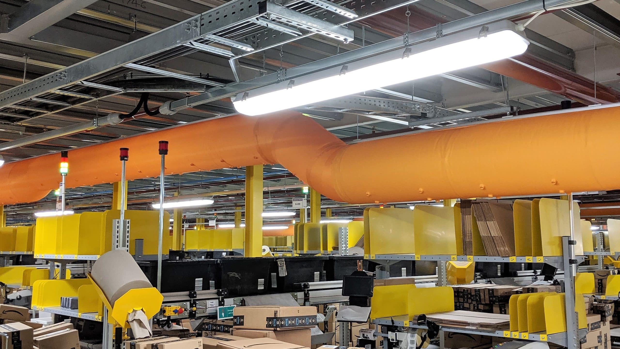 Orange fabric duct with nozzles and 45 degree bend