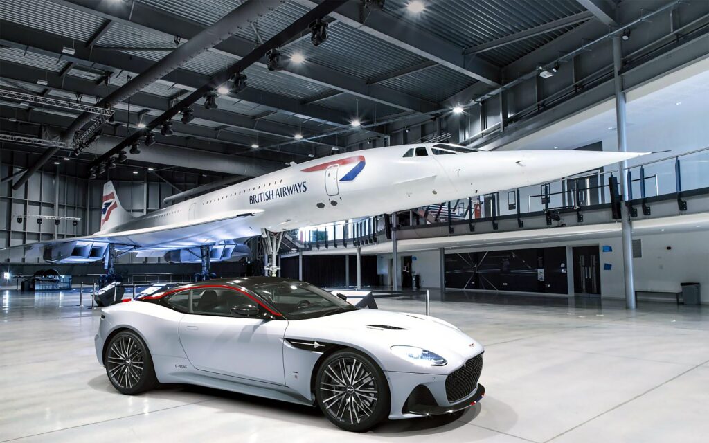 An Aston Martin and a Concorde aeroplane in a hangar with grey Prihoda fabric ducts